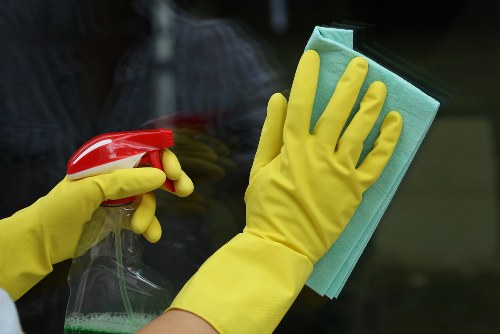 Carpet cleaner preparing equipment safely before work begins