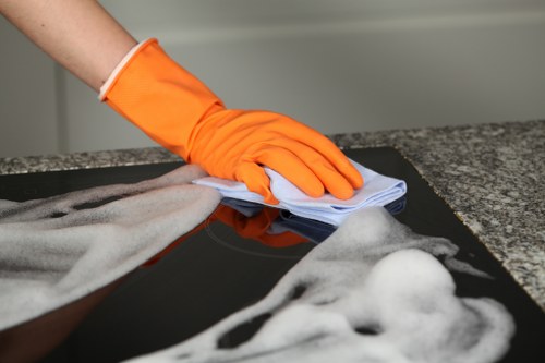 Professional carpet cleaner in SW20 treating a living room carpet