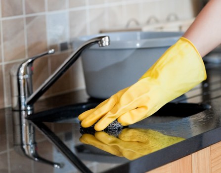 Carpet cleaning professional preparing equipment in SW20