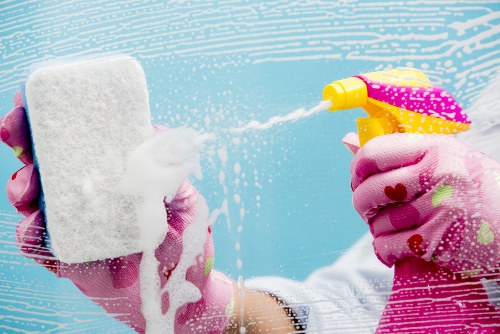 Professional carpet cleaners working on a home carpet in SW20
