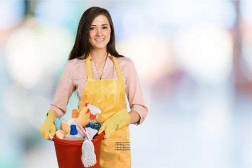 Cleaners in SW20 performing deep cleaning in a modern kitchen