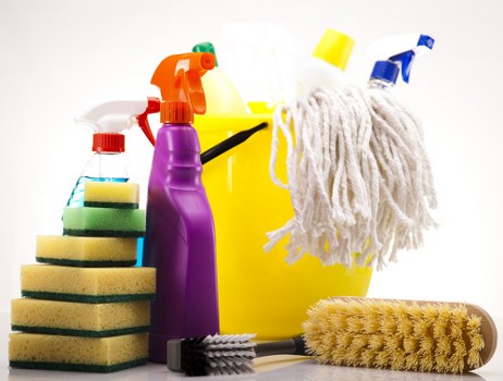 Operator using carpet cleaning machine with attention to cords and hoses